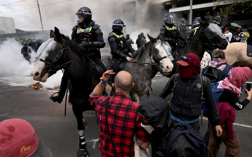 Protesters confront police outside the Land Forces 2024 arms fair in Melbourne on September 11, 2024. (Photo by William WEST / AFP)