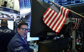 Traders and financial professionals work on the floor of the New York Stock Exchange ahead of the opening bell in New York City.