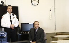 Kevin Spacey sits in chair while the legal teams meet during his arraignment at Nantucket District Court in Nantucket, Massachusetts on January 7, 2019.