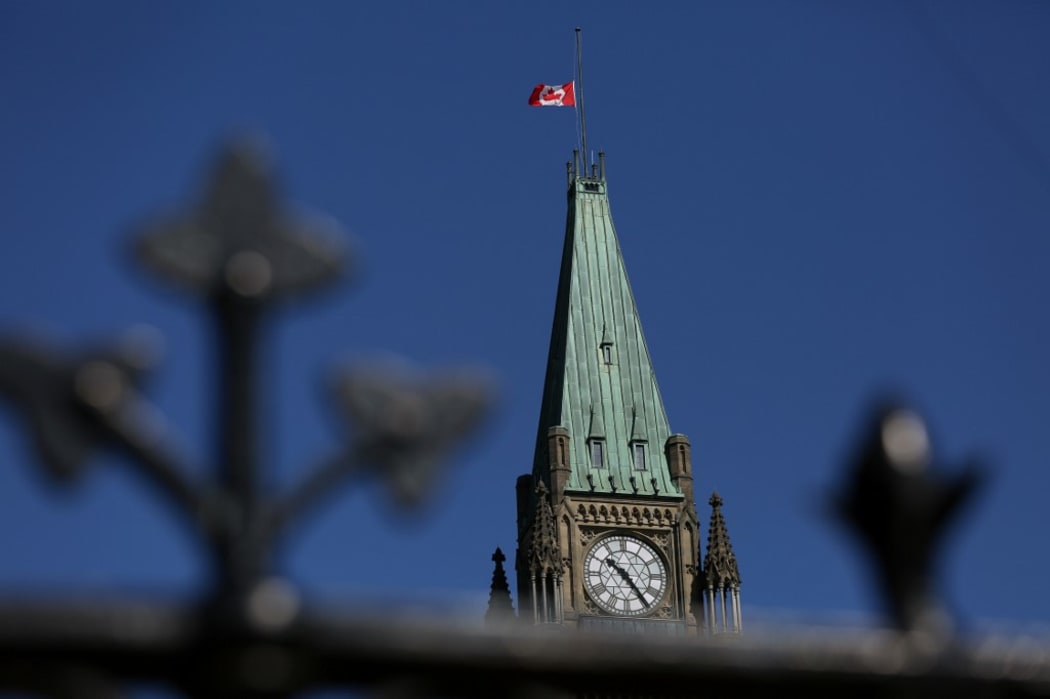 A Canadian flag flies at half-mast on top of the Peace Tower to mourn the victims of the of the Nova Scotia shooting April 20, 2020 in Ottawa, Canada.