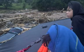 Huia Ngatai's family taking refuge on the roof of their home during the severe storm.