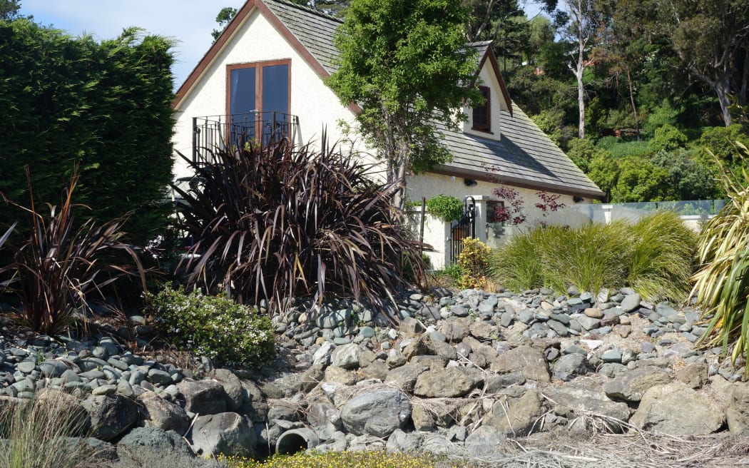 Nelson home-owner Gaire Thompson has been waiting more than a year for council consent for the rock wall outside his home.