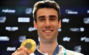 New Zealand high jumper Hamish Kerr shows off his Olympic gold medal