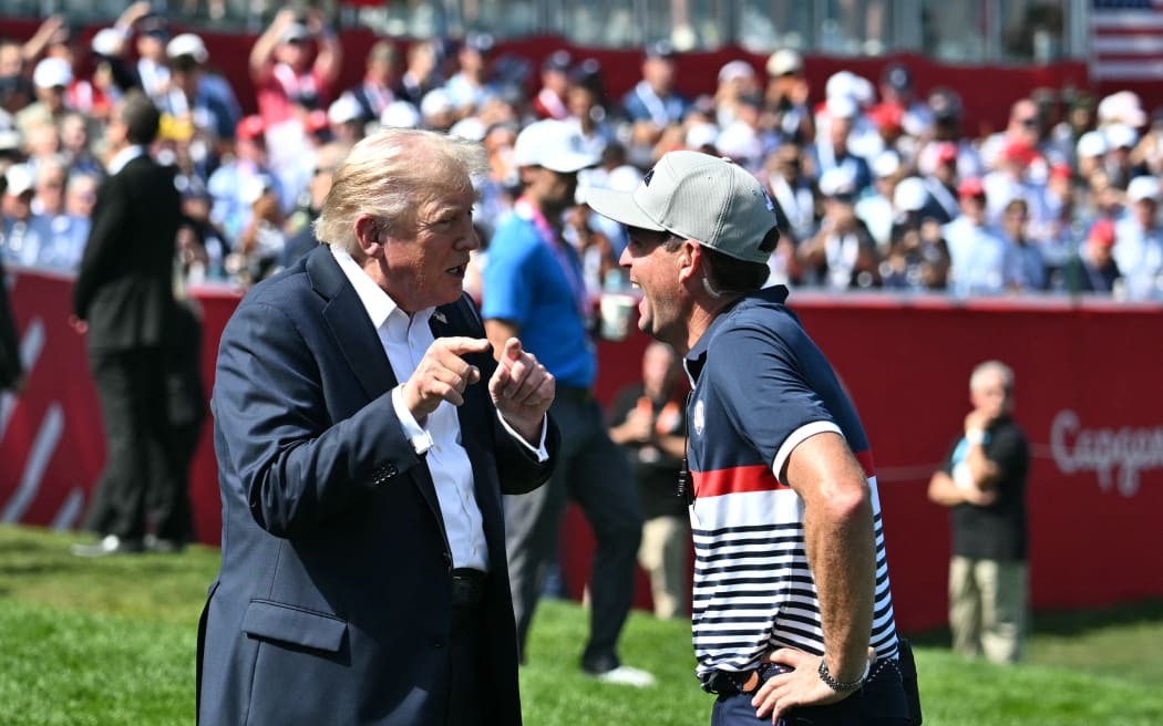 US President Donald Trump talks with US team captain pro-golfer Keegan Bradley at the Ryder Cup at Bethpage Black Course in Farmingdale, New York, on September 26, 2025. (Photo by Mandel NGAN / POOL / AFP)