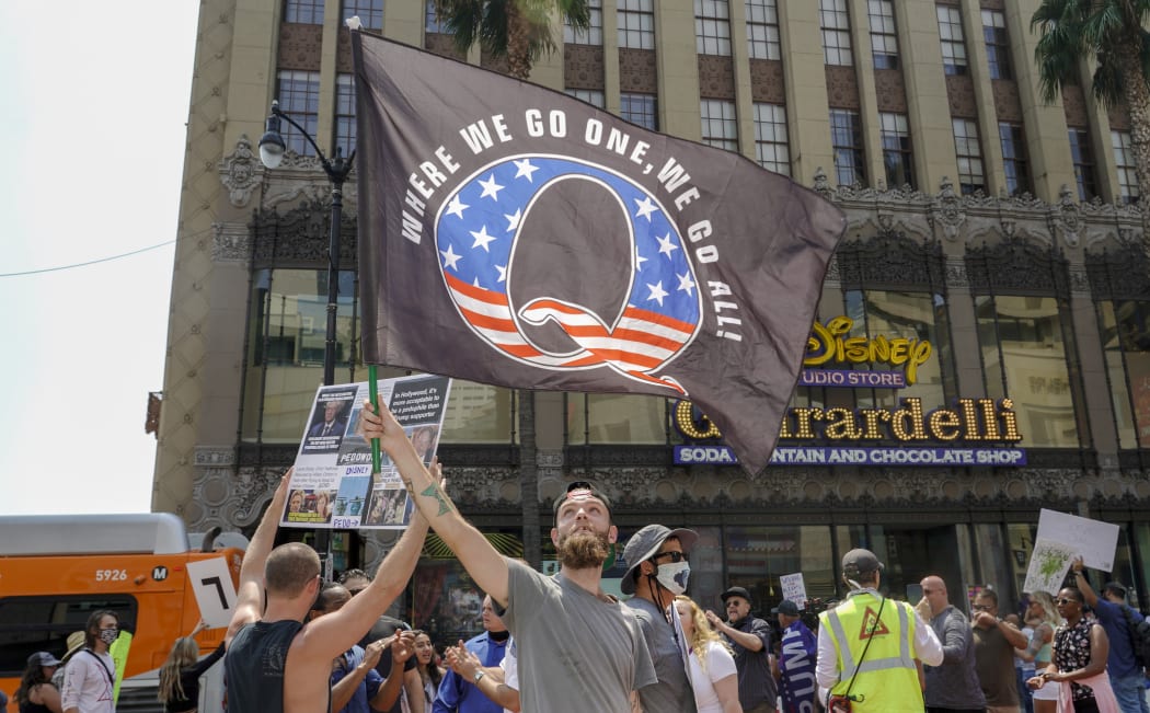 In this file photo conspiracy theorist QAnon demonstrators protest child trafficking on Hollywood Boulevard in Los Angeles, California, August 22, 2020.