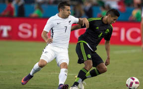 Kosta Barbarouses challenges for the ball against Mexico