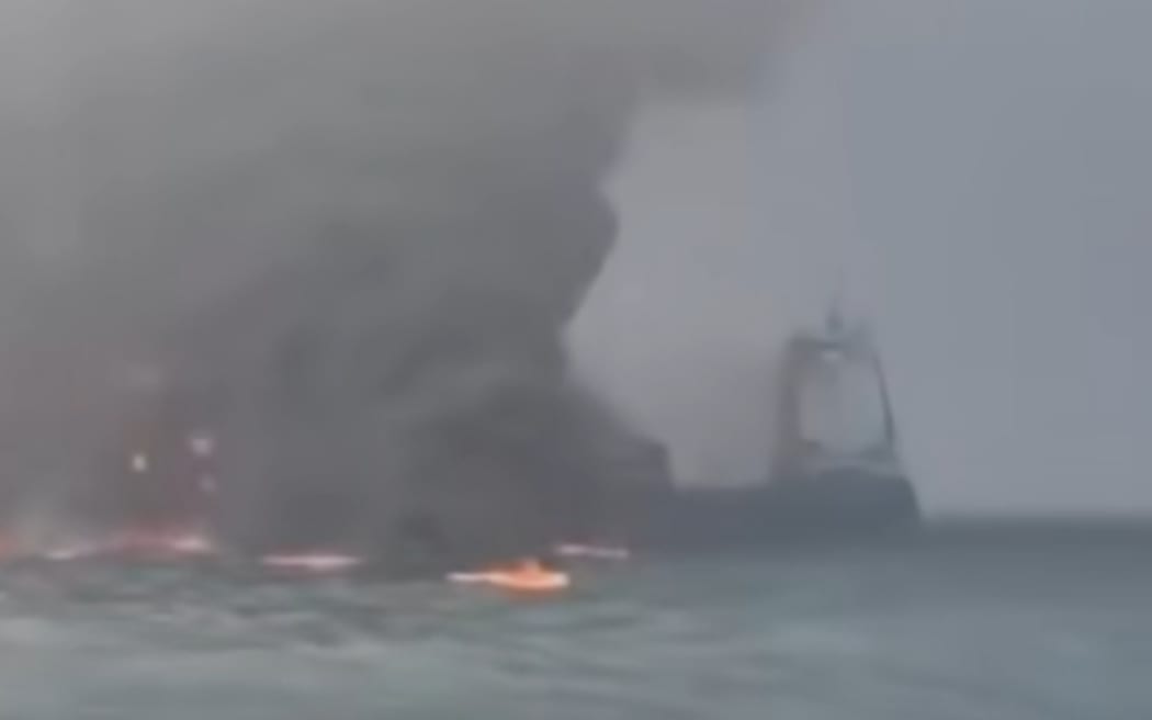 A screenshot from a video showing a vessel on fire after a collision off the northeast coast of England.