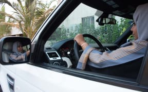 A Saudi woman drives her car in Jeddah, the day the ban was lifted