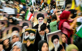 Shiite Muslims hold portraits of Iran's Supreme leader Ayatollah Ali Khamenei to condemn US and Israel's attacks on Iran, during a protest in Karachi on June 22, 2025. The United States struck three nuclear sites in Iran on June 22, joining Israel's bombing campaign after days of speculation over US involvement in the Iran-Israel conflict. (Photo by Asif HASSAN / AFP)