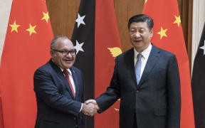 Papua New Guinea's Prime Minister Peter O'Neill (L) shakes hands with China's President Xi Jinping in June.