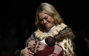 AUCKLAND, NEW ZEALAND - AUGUST 29: Kaiora Tipene with her baby Ngawaiata Irirangi Taimania Tipene on the runway during the Campbell Luke show during New Zealand Fashion Week 23: Kahuria at Viaduct Events Centre‎ on August 29, 2023 in Auckland, New Zealand.