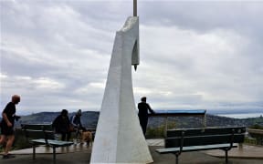 Visitors at the Centre of New Zealand in Nelson, overlooking the city and Tasman Bay.