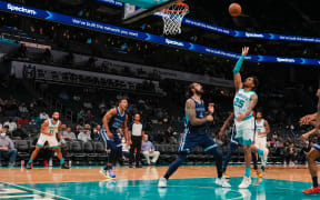 Charlotte Hornets forward P.J. Washington shoots over Memphis Grizzlies center Steven Adams during the first quarter at Spectrum Center.