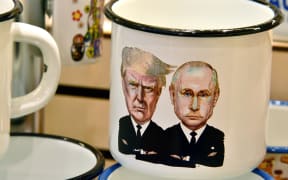 A souvenir shops offering among others cup a tin mug depicting Russian President Vladimir Putin and US President Donald Trump.
