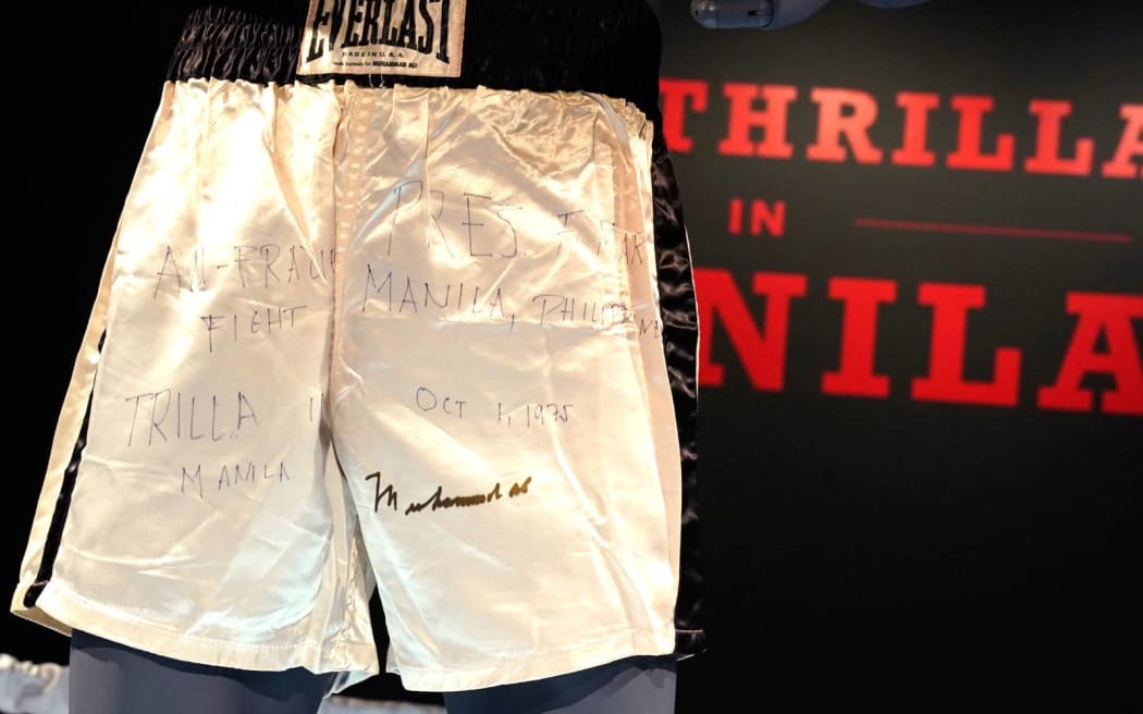 Muhammad Ali’s trunks worn during the 1975 legendary match against Joe Frazier, ‘The Thrilla in Manila’ are on display during 'Sports Week' auctions at Sotheby's in New York City on April 4, 2024. The shorts worn by Muhammad Ali in his legendary "Thrilla in Manila" boxing match are up for grabs at Sotheby's in New York, part of a growing sports memorabilia market eyed by auction houses.
Bids -- including the latest for $3.8 million -- have been rolling in since late March for the Everlast-brand shorts, which are white with black stripes and are signed by Ali. (Photo by TIMOTHY A. CLARY / AFP)