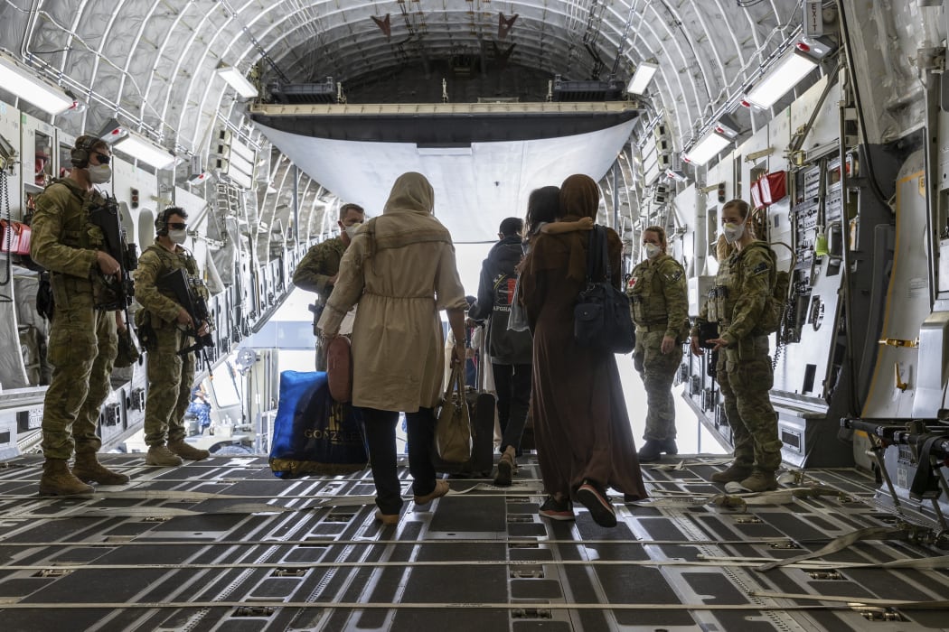 People disembark from an Australian Air Force plane after being evacuated from Afghanistan