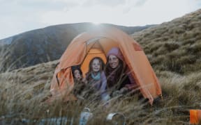 Sonia Barrish with her two children in a tent