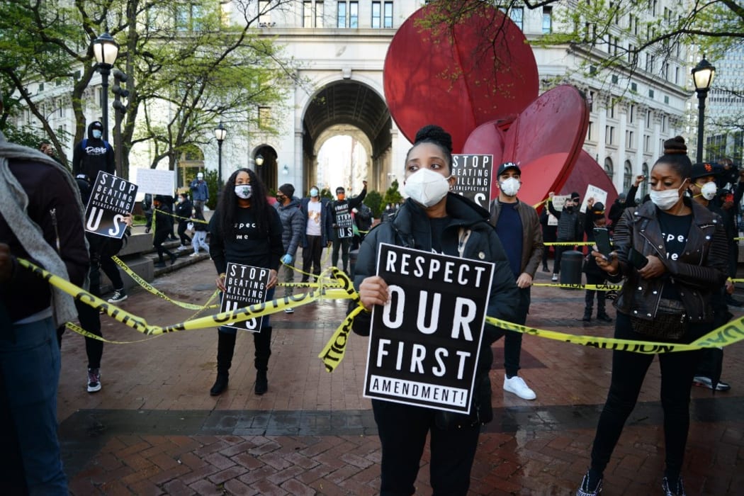 A large group of protesters, marched on New York's Police Headquarters decrying police brutality against African-Americans following the killing of Ahmaud Arbery, 11 May 2020, in New York.