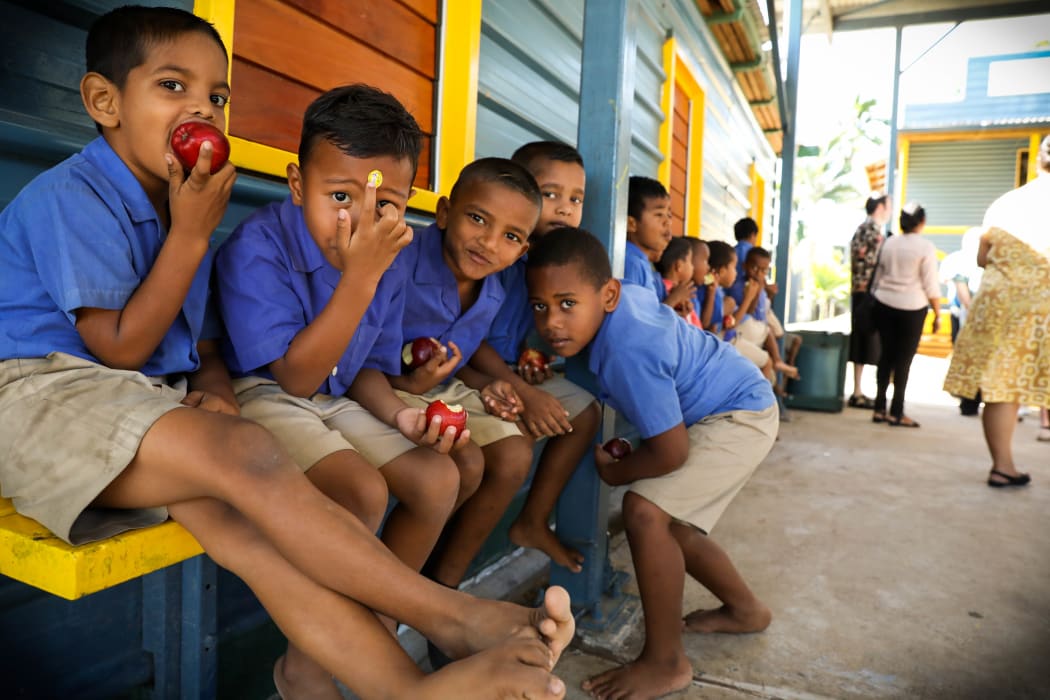 Squad. This group of children at Koroipita paused their apple eating to pose for a photo