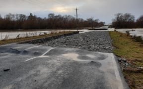 Part of the approach road to a bridge over the south branch of the Ashburton River  is washed away.