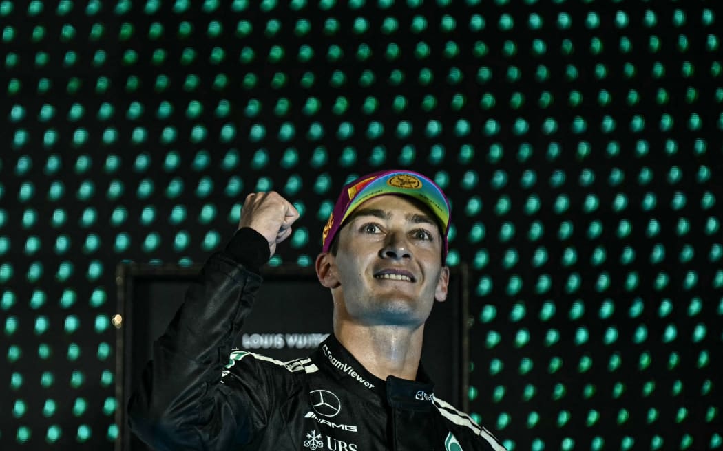 Mercedes' George Russell celebrates victory in the Formula One Singapore Grand Prix night race at the Marina Bay Street Circuit, 6 October 2025. (Photo by Lillian SUWANRUMPHA / AFP)