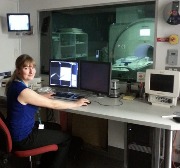 A photo of Susann Beier in the MRI control room