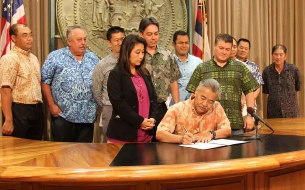 Hawaii Governor David Ige signs the bill into law on how to fund a Honolulu rail shortfall to complete construction.