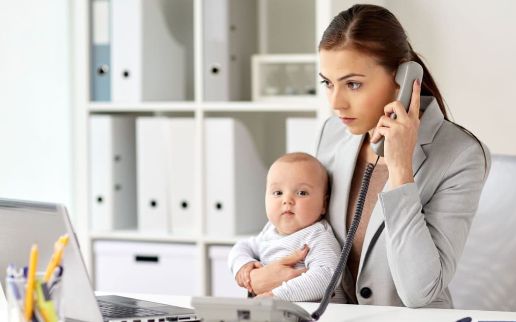 business, motherhood, multi-tasking, family and people concept - businesswoman with baby calling on phone at office