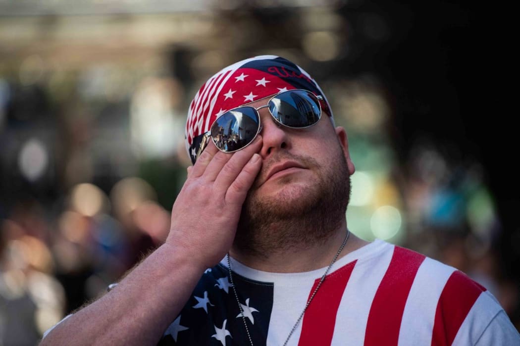 Joe Walker, a man who lives in the neighborhood, wipes a tear from his face as he participates in the 20th anniversary of the 9/11 attacks on the World Trade Center near the 9/11 Memorial & Museum in New York, on September 11, 2021.