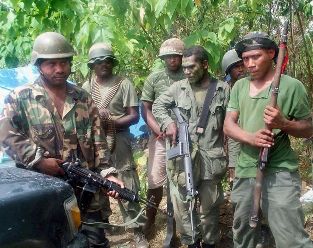 Malaita Eagle Force MEF rebels stand guard at their post in Honiara 12 June 2000. Credit Arthur WateSolomon StarAFP
