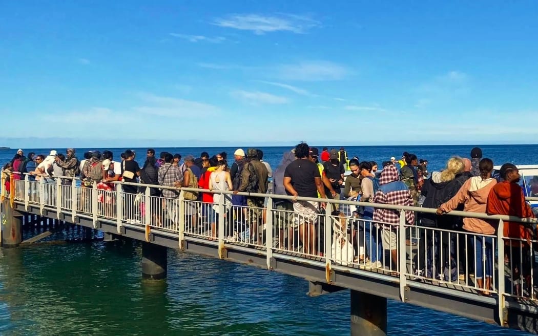 Passengers waiting for the ferry to reach Nouméa by sea