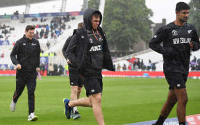 Tom Latham and Ish Sodhi run from the rain showers as the Black Caps' World Cup game against India is called off.