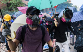 Tear gas is fired by police as protesters attempt to escape the campus of the Hong Kong Polytechnic University in the Hung Hom district of Hong Kong on November 18, 2019.