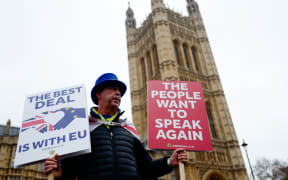 Anti-Brexit activist Steve Bray stands holding placards outside the Houses of Parliament in central London on January 16, 2019.