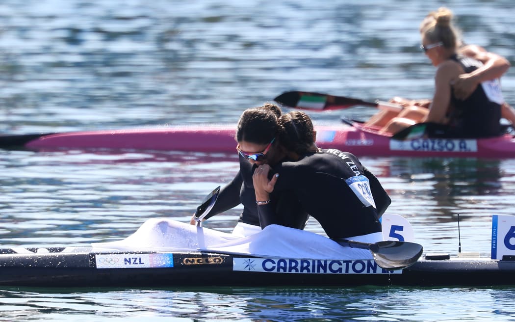 Lisa Carrington (hugging Aimee Fisher) of New Zealand wins gold in the women’s Kayak Single 500m gold medal final at Vaires-sur-Marne Nautical Stadium-flat water, Paris.