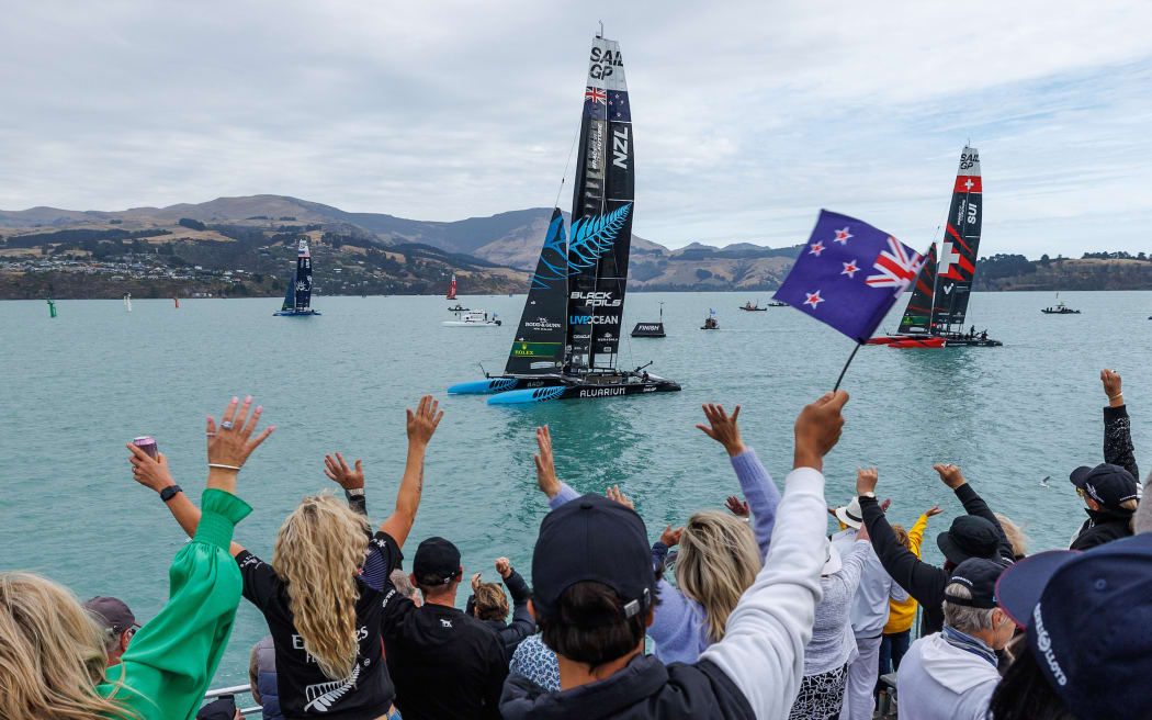 Spectators in the grandstand cheering the New Zealand SailGP Team Whilst the racing is on hold due to a dolphin sighting on the course on Race Day 1 of the New Zealand Sail Grand Prix in Christchurch, 2024.