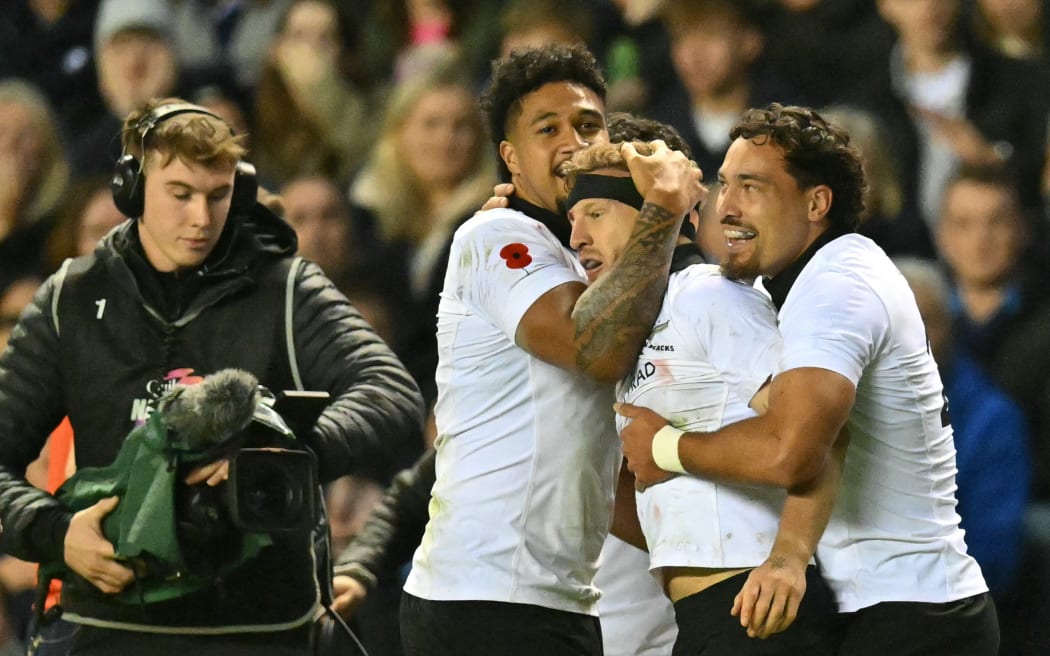 New Zealand's Damian McKenzie celebrates scoring a try against Scotland.