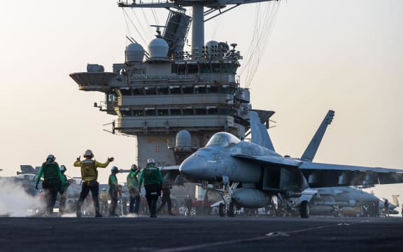 This 1 April photo from the US Navy shows a F/A-18E Super Hornet preparing for launch on the USS Harry S. Truman.
