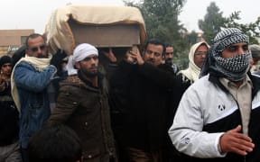 The coffin of a man killed in fighting is being carried for burial in Fallujah.