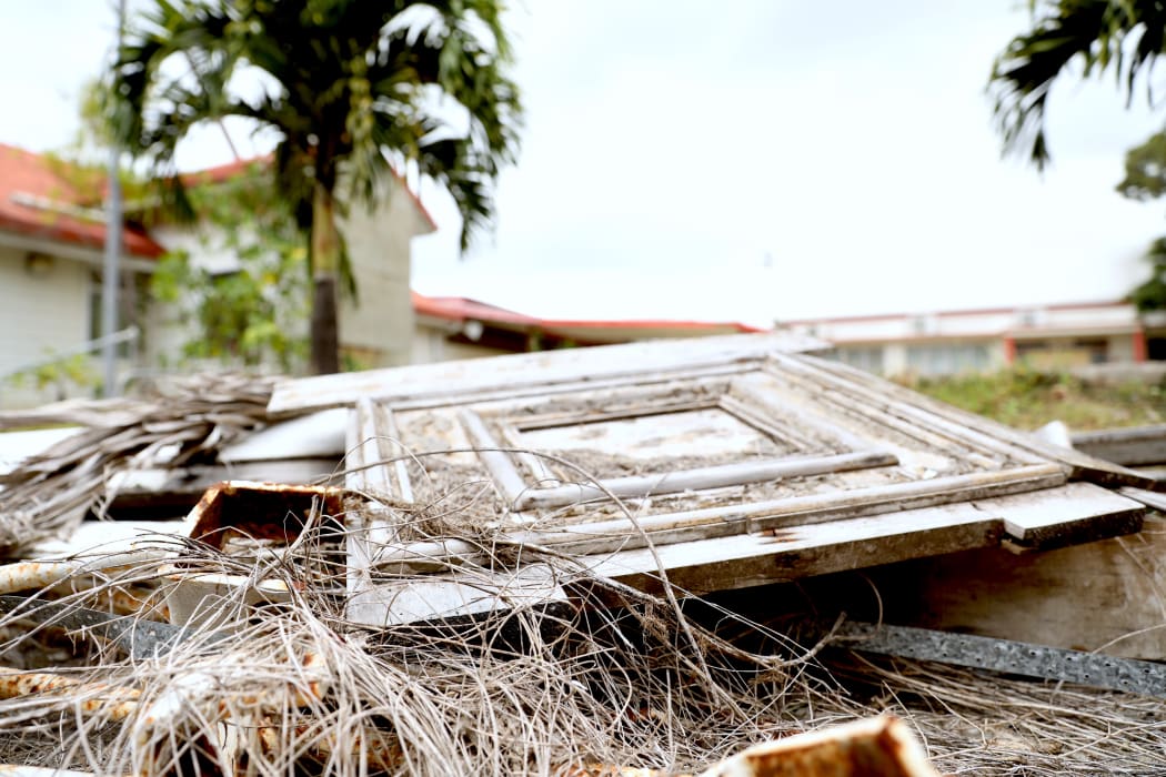 Tonga's Parliament was severely damaged by Cyclone Gita in 2018. Panels of wood, metal poles, and concrete are still scattered around the site.