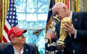FIFA President Gianni Infantino hands the Jules Rimet trophy to Donald Trump in the Oval Office on 22 August.
