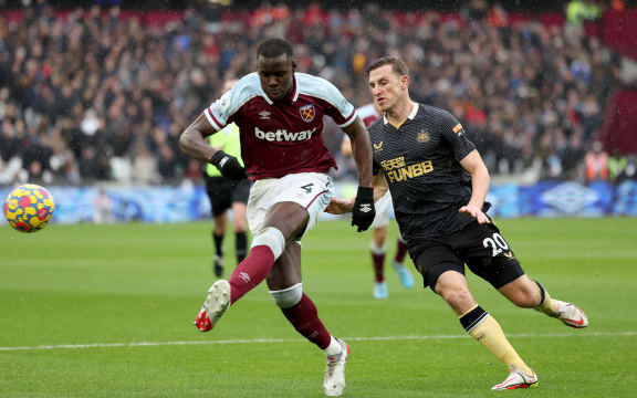 Kurt Zouma of West Ham United clears the ball from Chris Wood of Newcastle United.