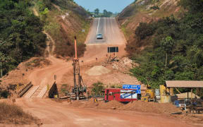 A pickup truck drives near a of the Trans-Amazonian highway (BR230) under construction, near Ruropolis, Para state, Brazil, in the Amazon rainforest, on September 7, 2019.