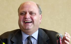 Former World Trade Organisation chief Mike Moore speaks at a press conference 14 February 2000 in Singapore.