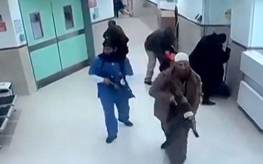 This grab taken from a UGC video released on social media on January 30, 2024 shows CCTV footage displayed on a computer screen reportedly of a deadly raid by undercover Israeli troops at the Ibn Sina hospital in the northern city of Jenin in the occupied West Bank. Israeli undercover agents, some disguised as medical staff, raided a West Bank hospital on January 30 and shot dead three Palestinian militants, in the first such operation in eight years. The Israeli military said forces entered the hospital -- a major health facility serving Jenin city and its adjacent refugee camp -- to target a "Hamas terrorist cell". (Photo by UGC / AFP) / RESTRICTED TO EDITORIAL USE – MANDATORY CREDIT «  AFP PHOTO / SOCIAL MEDIA  » - NO MARKETING NO ADVERTISING CAMPAIGNS – DISTRIBUTED AS A SERVICE TO CLIENTS