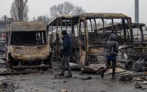 Local residents inspect damaged cars at the site of a Russian attack in Odesa on February 13, 2026, amid the Russian invasion of Ukraine.