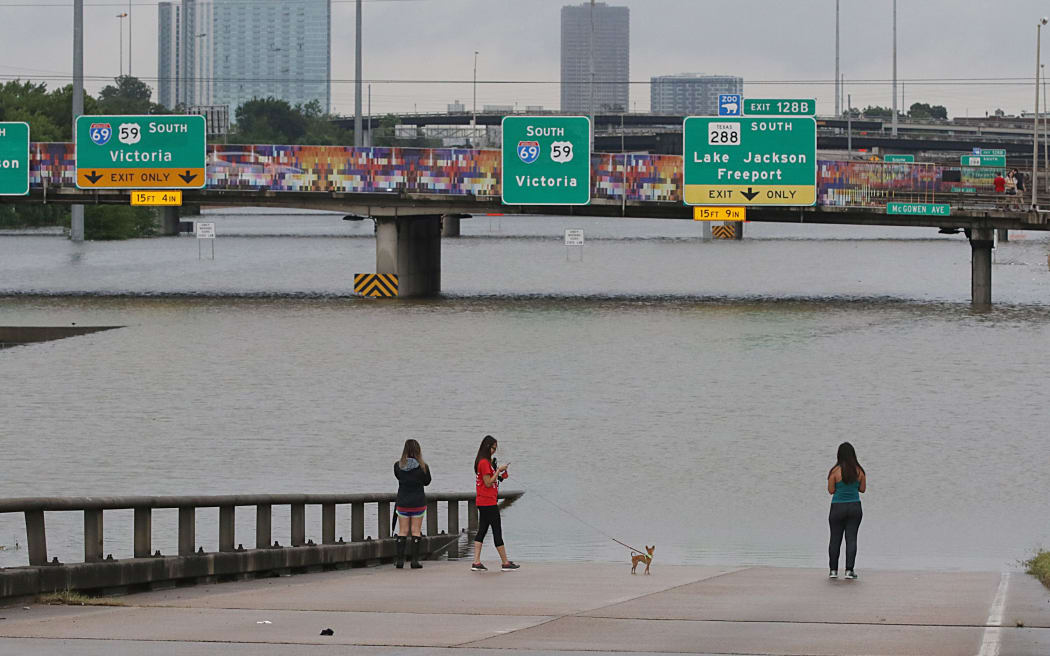 Heavy flooding on Houston's freeway has cut off entire suburbs.