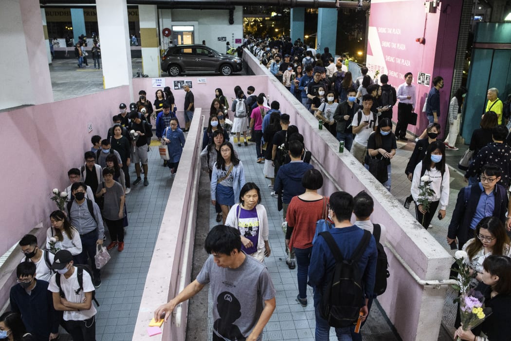 Mourners queue to pay their respects at the car park where student Alex Chow, 22, fell during a recent protest in the Tseung Kwan O area on the Kowloon side of Hong Kong on November 8, 2019.