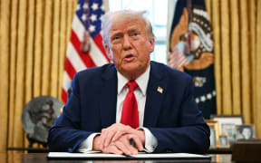 US President Donald Trump speaks to the press in the Oval Office at the White House.