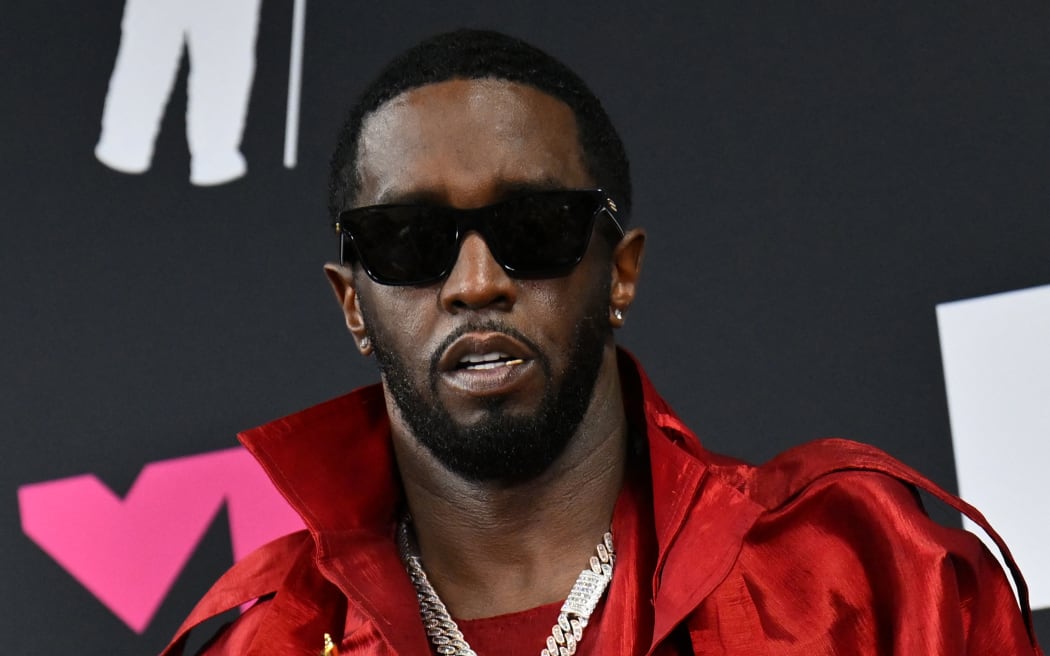 (FILES) US producer-musician Sean "Diddy" Combs poses with the Global Icon award in the press room during the MTV Video Music Awards at the Prudential Center in Newark, New Jersey, on September 12, 2023. Once hip hop's flashy impresario credited with commercializing the genre, Sean "Diddy" Combs has seen his star plunge as federal authorities raid his homes amid sex trafficking accusations and assault lawsuits. (Photo by ANGELA WEISS / AFP)